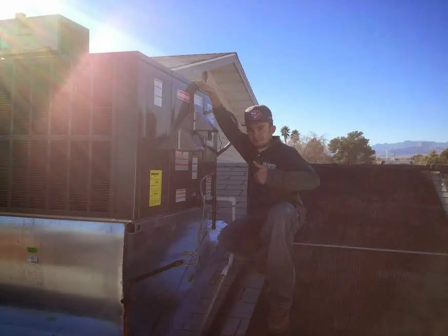 HVAC technician performing HVAC Inspection on a rooftop unit in Cumberland